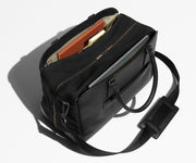 Two exterior slip pockets packed with a laptop and notebooks