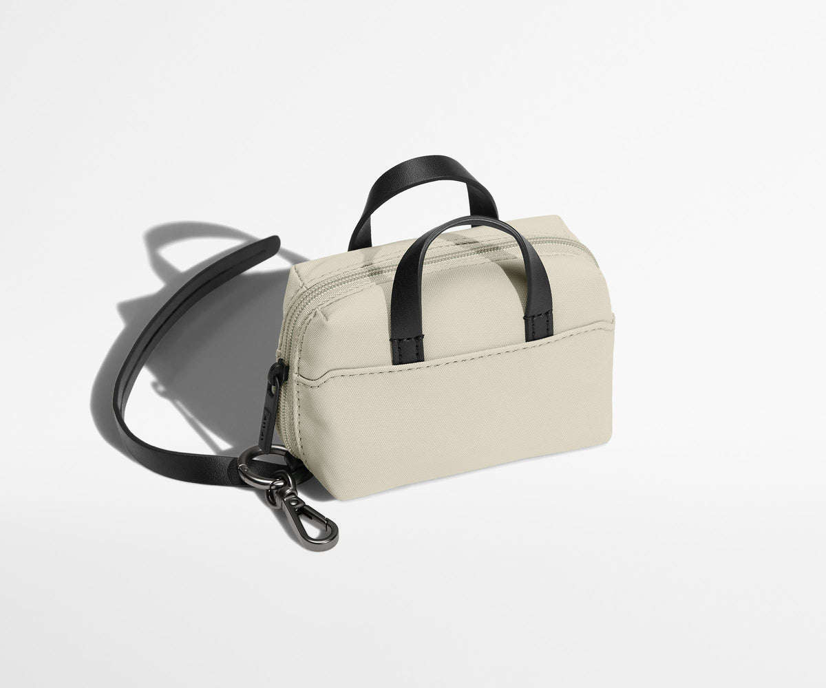 The Micro Everywhere Bag with a strap that attaches to any bag or suitcase