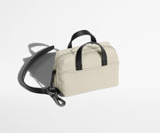 The Micro Everywhere Bag with a strap that attaches to any bag or suitcase