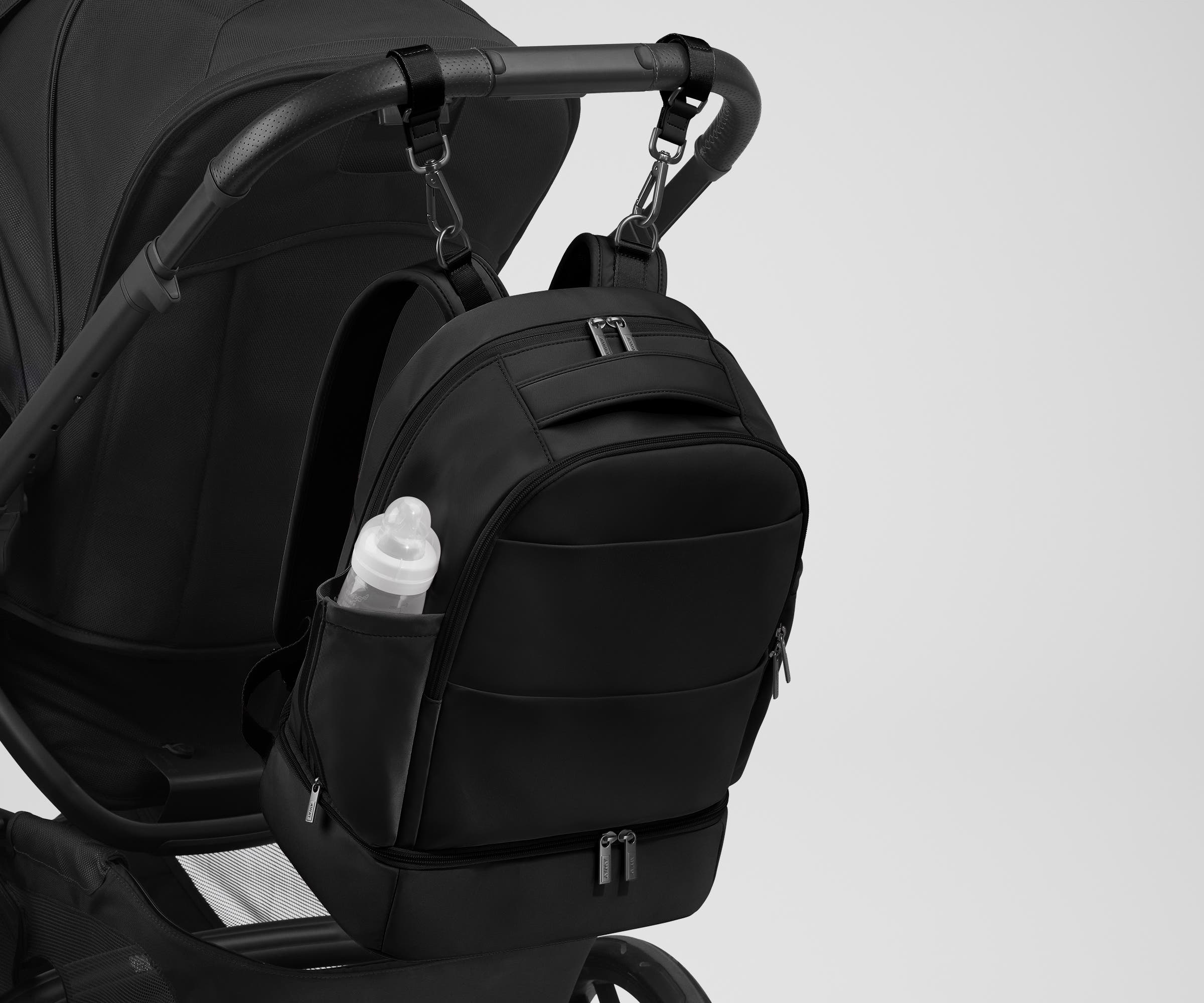 Backpack attached to a stroller using the included stroller clips