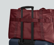 Active Tote 45L secured to an Away suitcase by its trolley strap