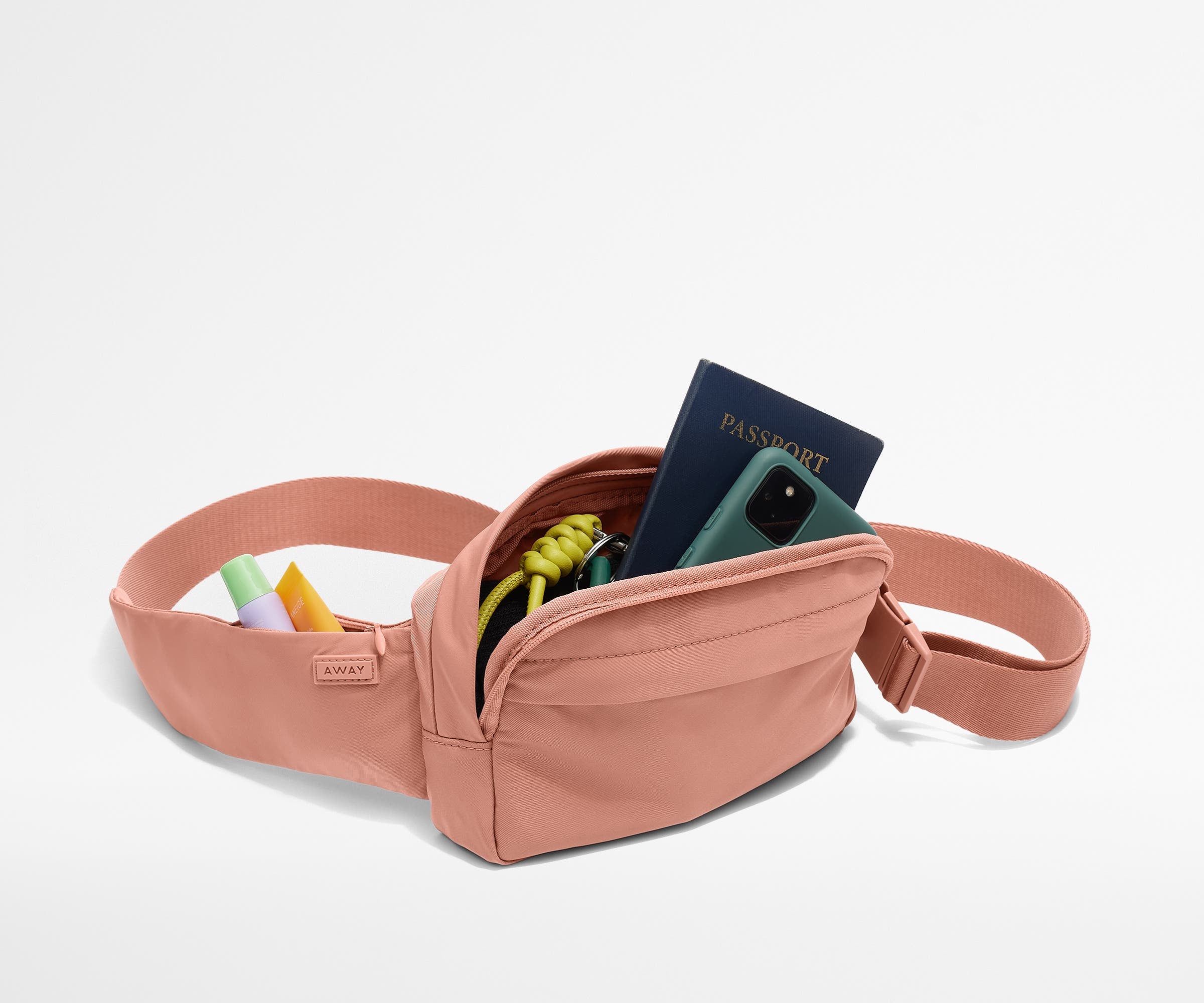 Sling Bag packed with a phone, passport, keys, and chapstick