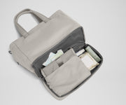Bottom compartment shown with the included changing pad and Carry-All pouch that fits diapers and wipes