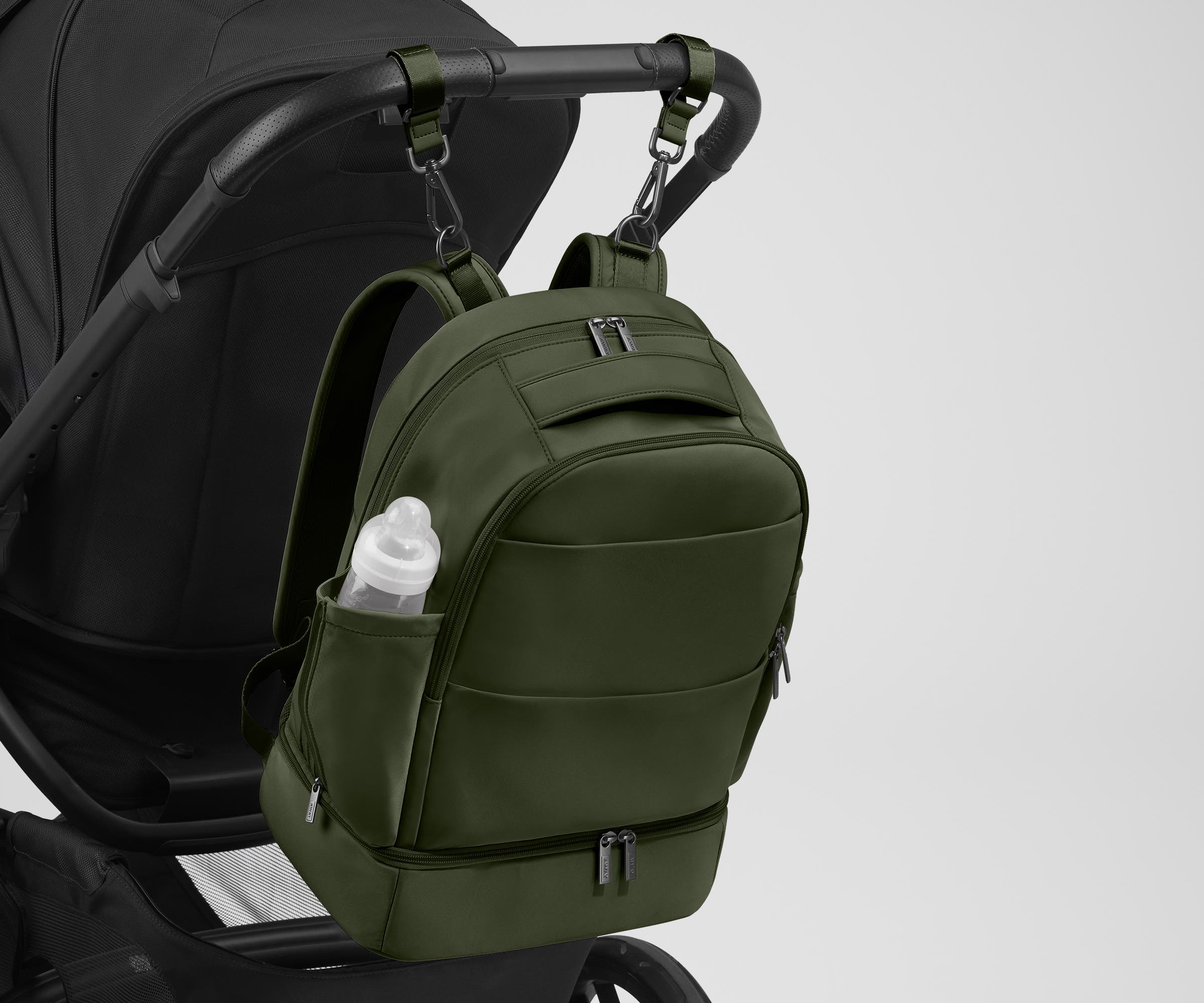 Backpack attached to a stroller using the included stroller clips