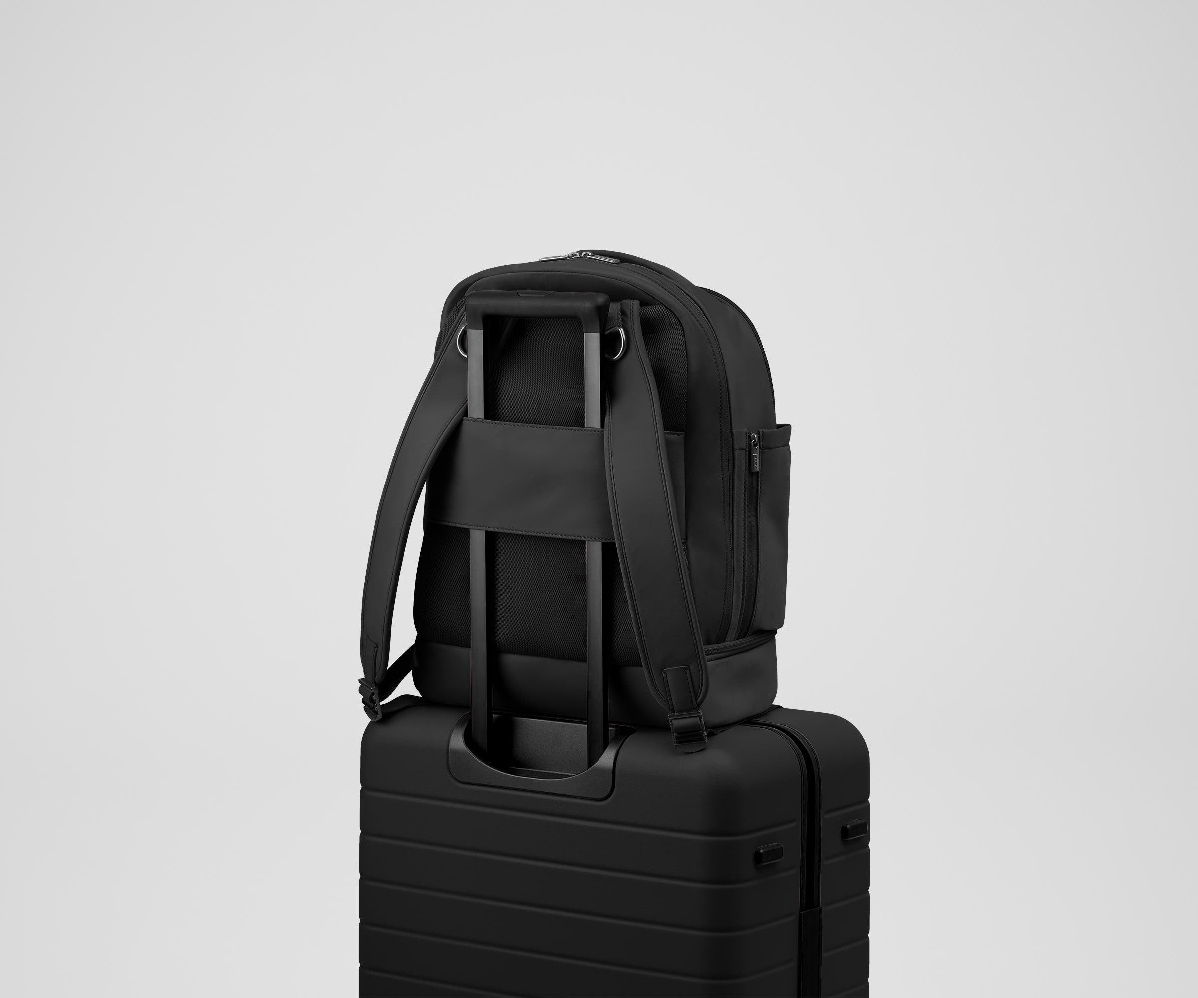 Double Diaper Backpack on top of an Away suitcase by the trolley sleeve