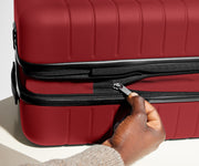 The Bigger Carry-On Flex suitcase in Tango Red has an additional wraparound zipper to expand the suitcase 2.25" (6 cm) and increase packing space