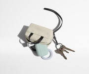 Micro Everywhere Bag packed with earpods, chapstick, and keys attached