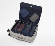 Open Softside suitcase, with travel essentials in the front flap pocket and compression pad pockets