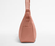 Side view of the Large Featherlight Crossbody showing the exterior bottle pocket