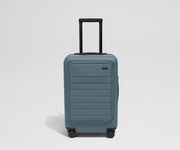 Front product view of The Front Carry-On suitcase in Coast Blue with raised handle