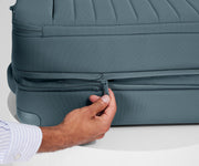 Person expanding the bag, using the wraparound zipper