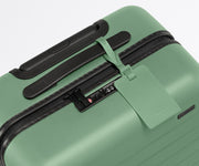 The leather luggage tag on top of a matching Away suitcase