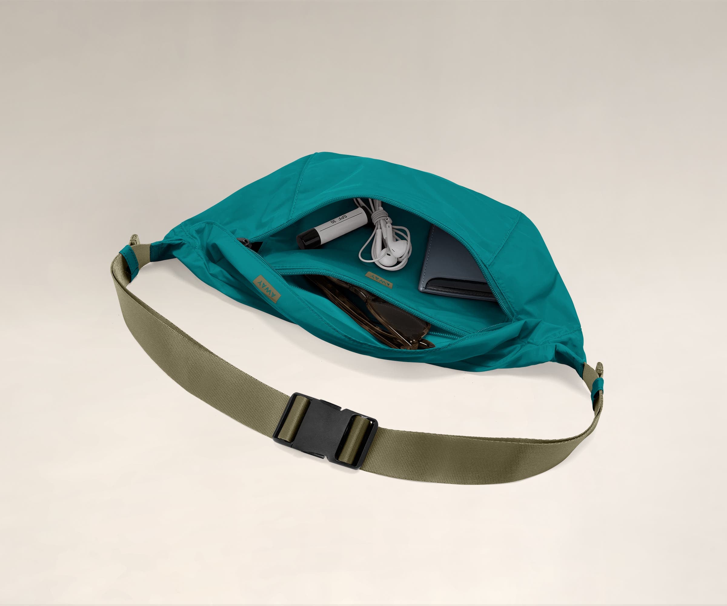 Main compartment packed with a wallet, headphones, and sunglasses