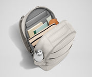 Back main compartment packed with adult travel essentials, including a laptop, notebook, and extra clothes