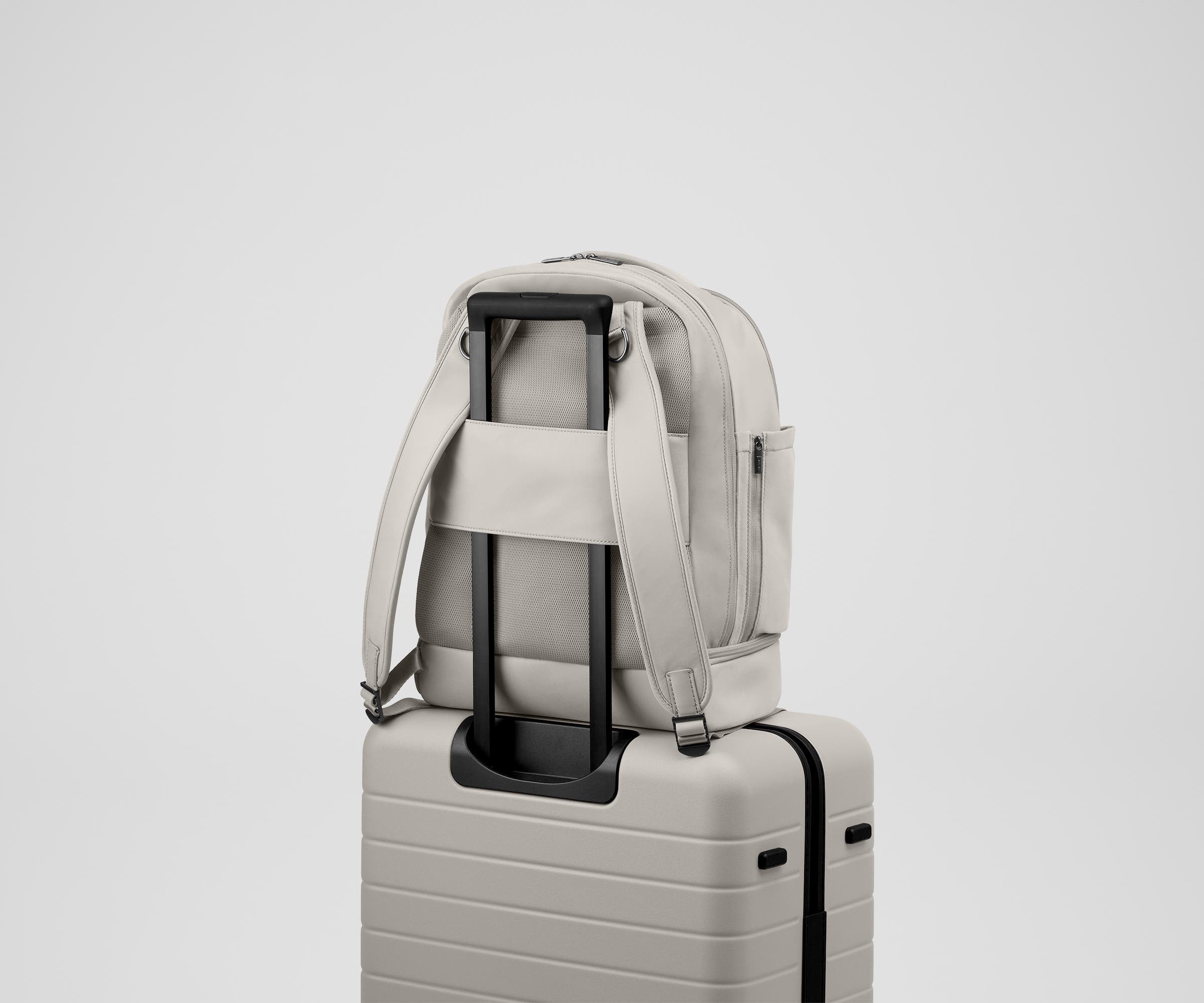 Double Diaper Backpack on top of an Away suitcase by the trolley sleeve