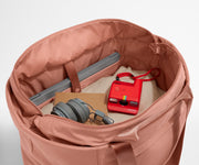 Interior packed with clothing, a laptop, headphones, notebook, and camera