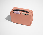 Exterior zip pocket packed with a comb and other toiletries