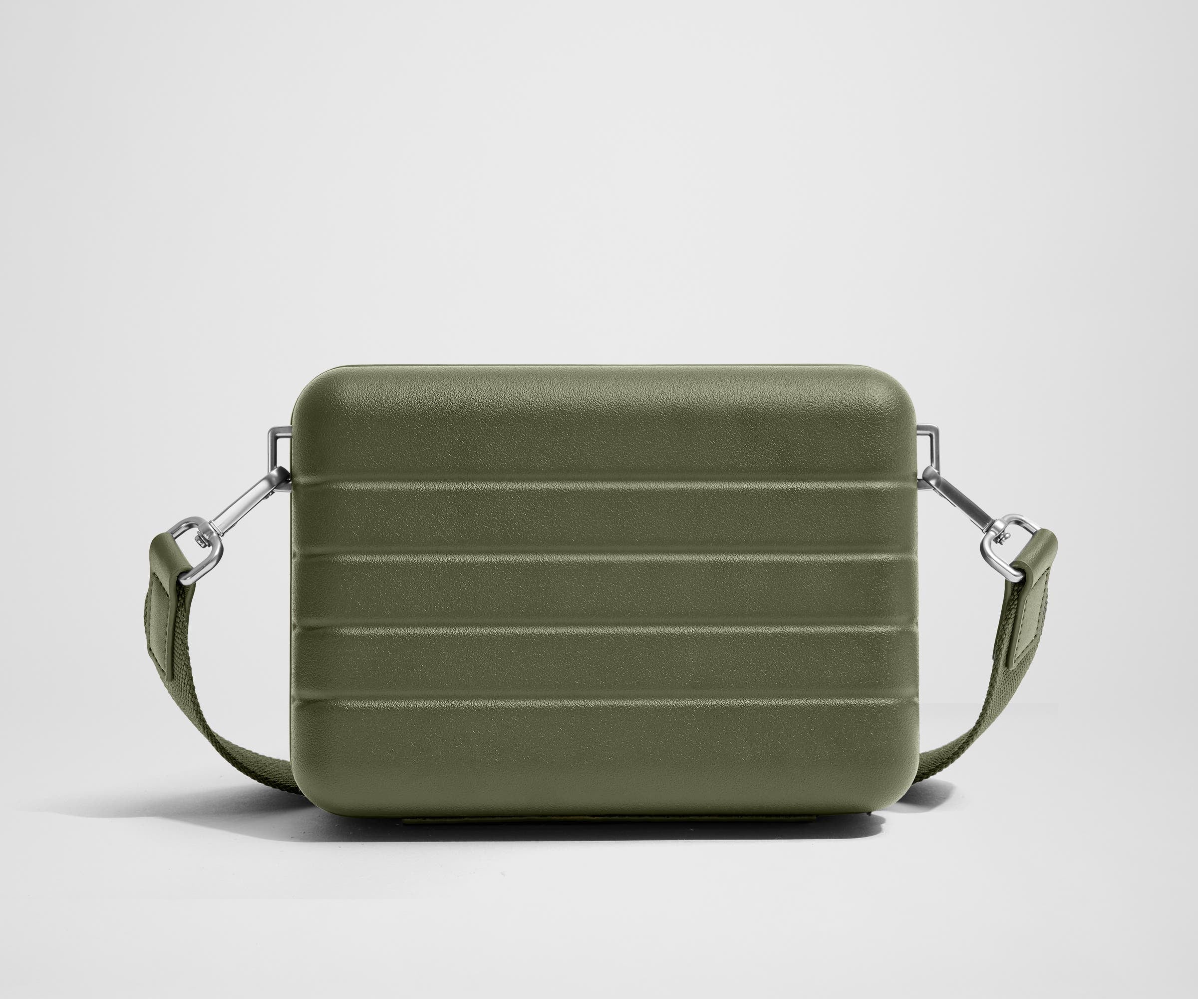 Unzipped, open view of The Mini Crossbody, showing the two main compartments and slip pocket