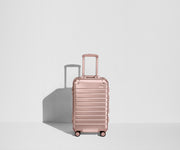 Front view of a Bigger Carry-On: Aluminum Edition suitcase with handles raised