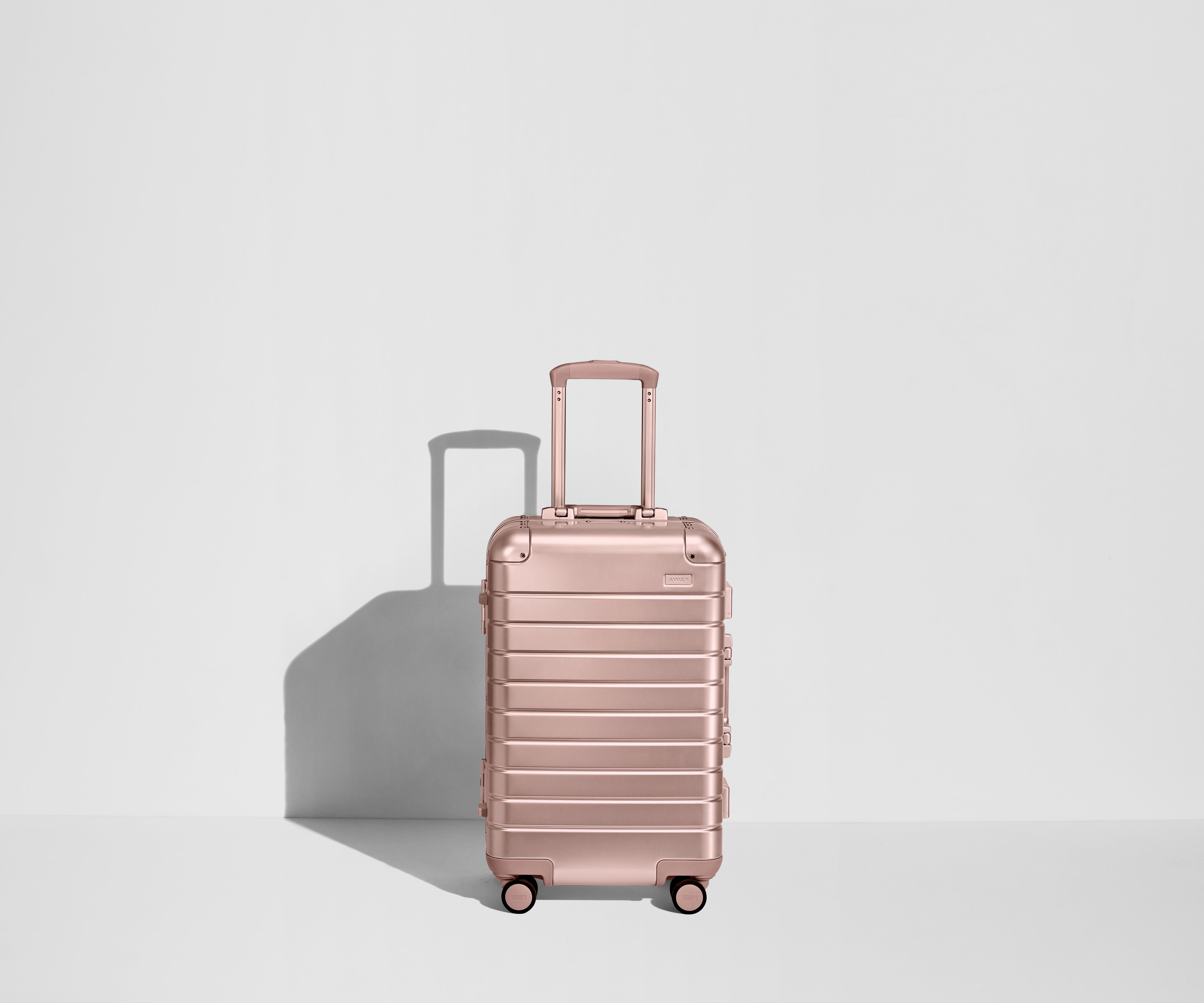 Front view of a Bigger Carry-On: Aluminum Edition suitcase with handles raised