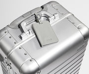 Color-matching Silver luggage tag that comes with the Aluminum suitcase