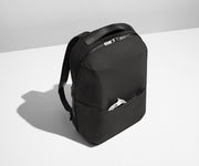 Angled product view of the Everywhere Zip Backpack with a charging cord in the exterior front pocket
