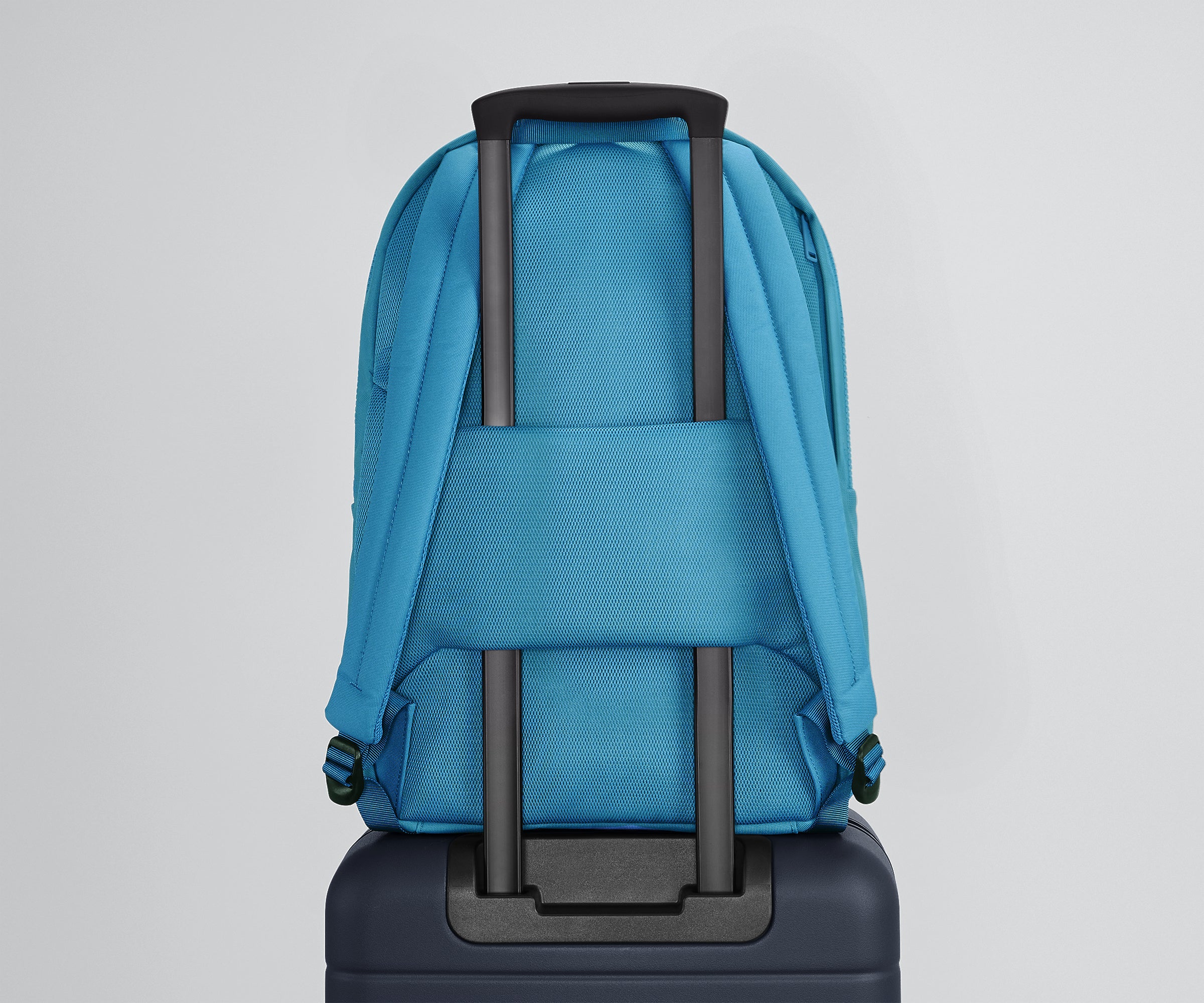 Active Backpack 26L secured to an Away suitcase