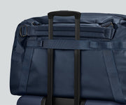 55L duffle bag secured to an Away suitcase by the trolley sleeve