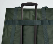Active Tote 45L secured to an Away suitcase by its trolley strap