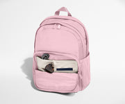 Pink backpack with a pocket open on a white background