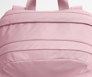 Close-up of a pink backpack with visible stitching details.