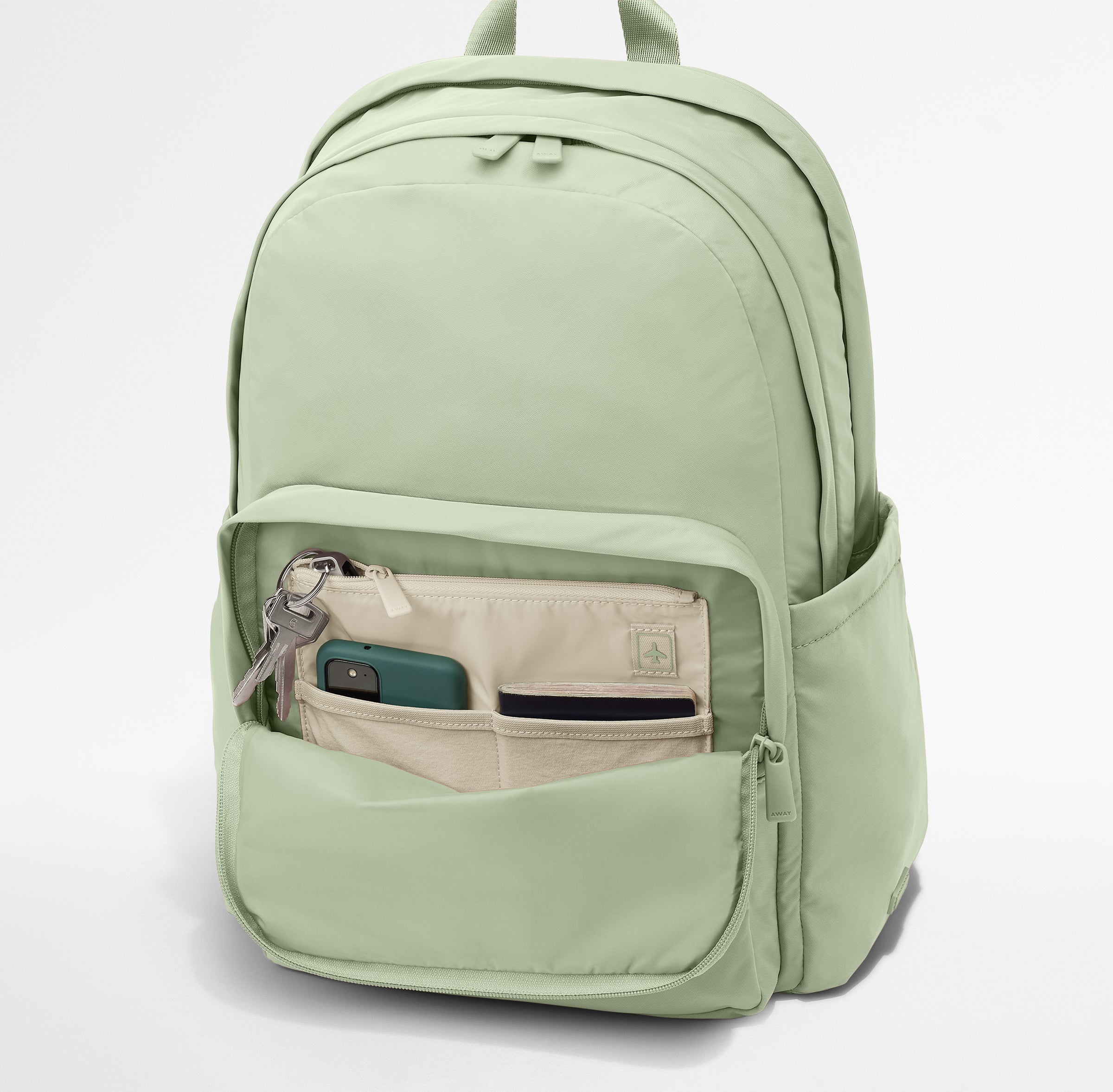 Phone, passport, and keys in their dedicated pockets in the front zip pocket