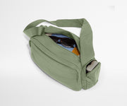 Featherlight Cargo Pack packed with notebooks, sunglasses, and a camera