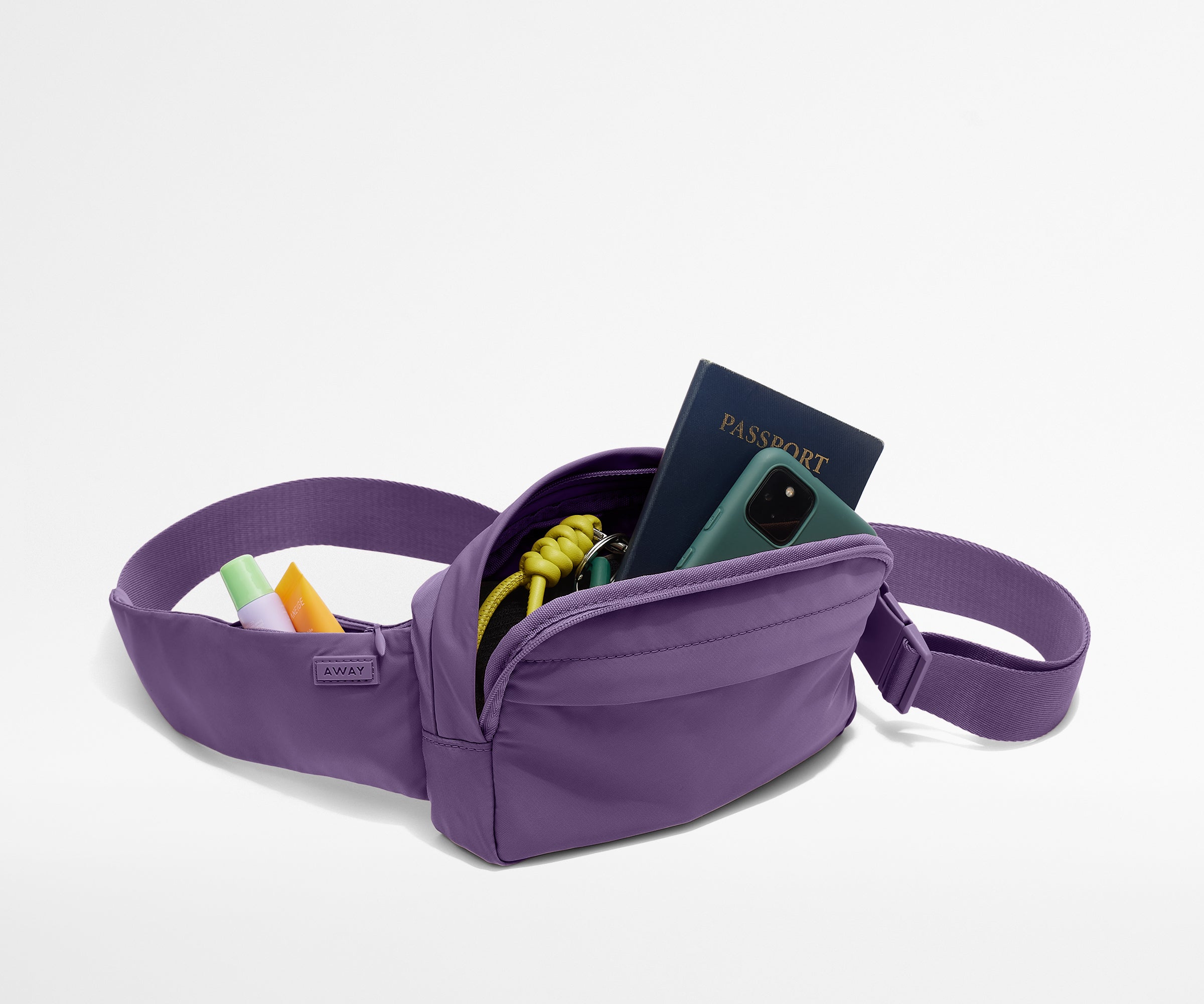 Sling Bag packed with a phone, passport, keys, and chapstick
