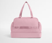 Pink duffel bag on a light gray background