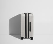 Side product view of The Bigger Carry-On Flex suitcase in Cloud Gray shown fully expanded