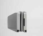 Side product view of The Carry-On Flex suitcase in Cloud Gray shown fully expanded