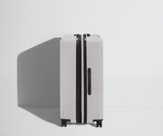 Side product view of The Large Flex suitcase in Cloud Gray shown fully expanded