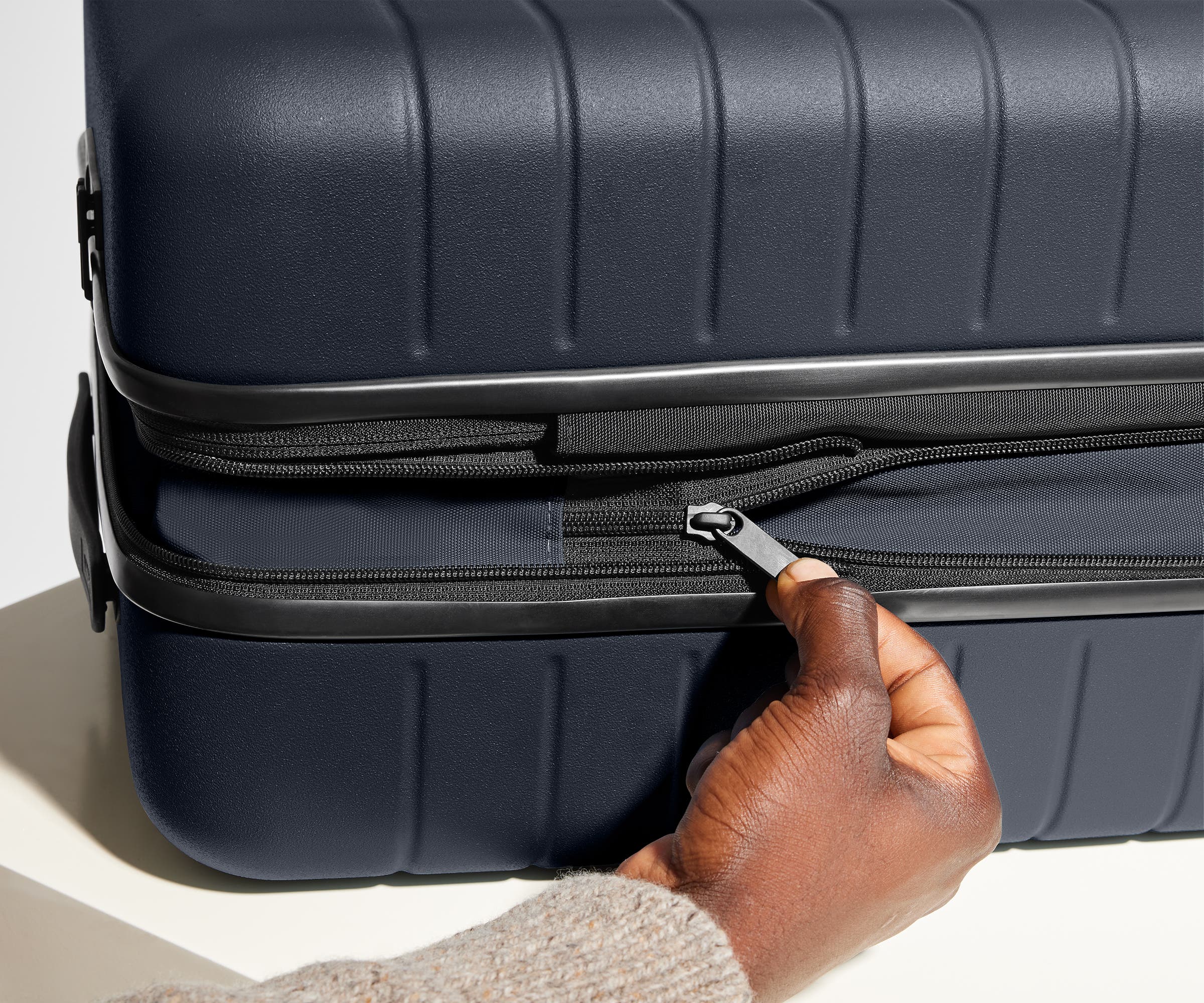 Hand unzipping the additional wraparound expandsion feature
