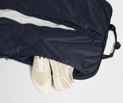 Showing one of two dedicated shoe pockets of the Garment Bag in Navy Blue
