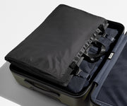 Folded Garment Sleeve clipped inside a checked suitcase