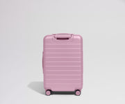 Pink suitcase on a light gray background