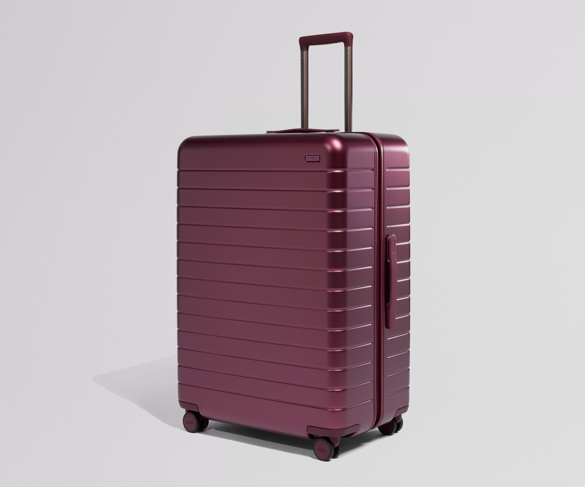 Maroon suitcase on a light gray background