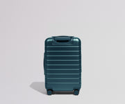 Teal suitcase on a light gray background