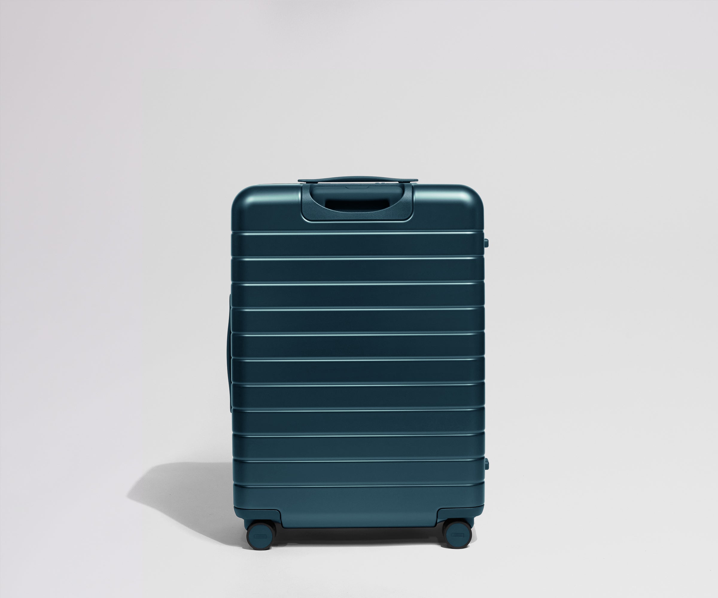 Teal suitcase on a light gray background