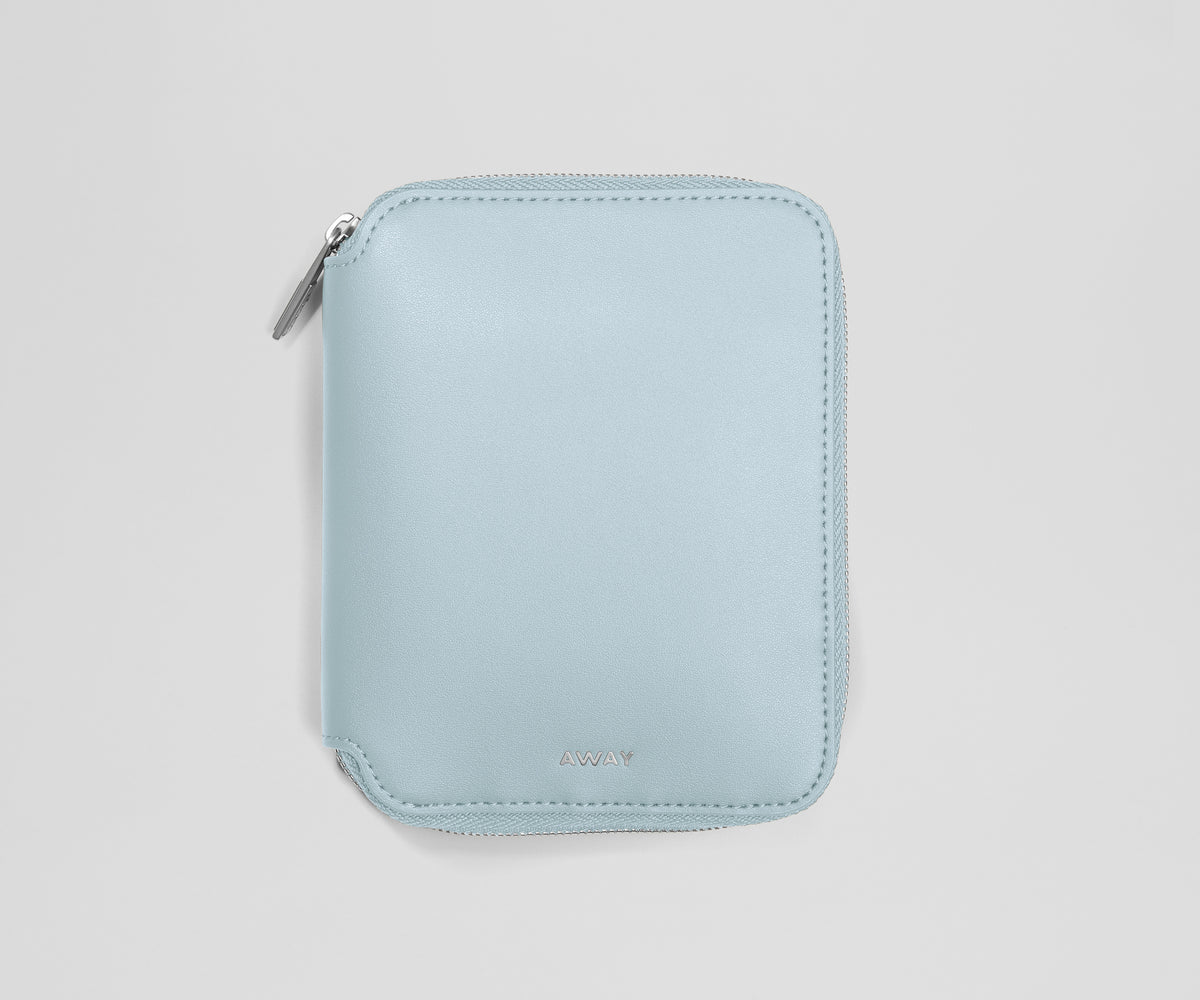 Light blue zippered jewelry organizer on a light gray background