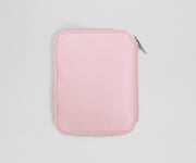 Pink zippered jewelry case on a light gray background