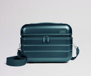 Teal travel case with a strap on a light gray background