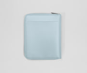 Light blue zippered leather wallet on a light gray background