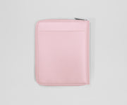 Pink travel wallet on a light gray background
